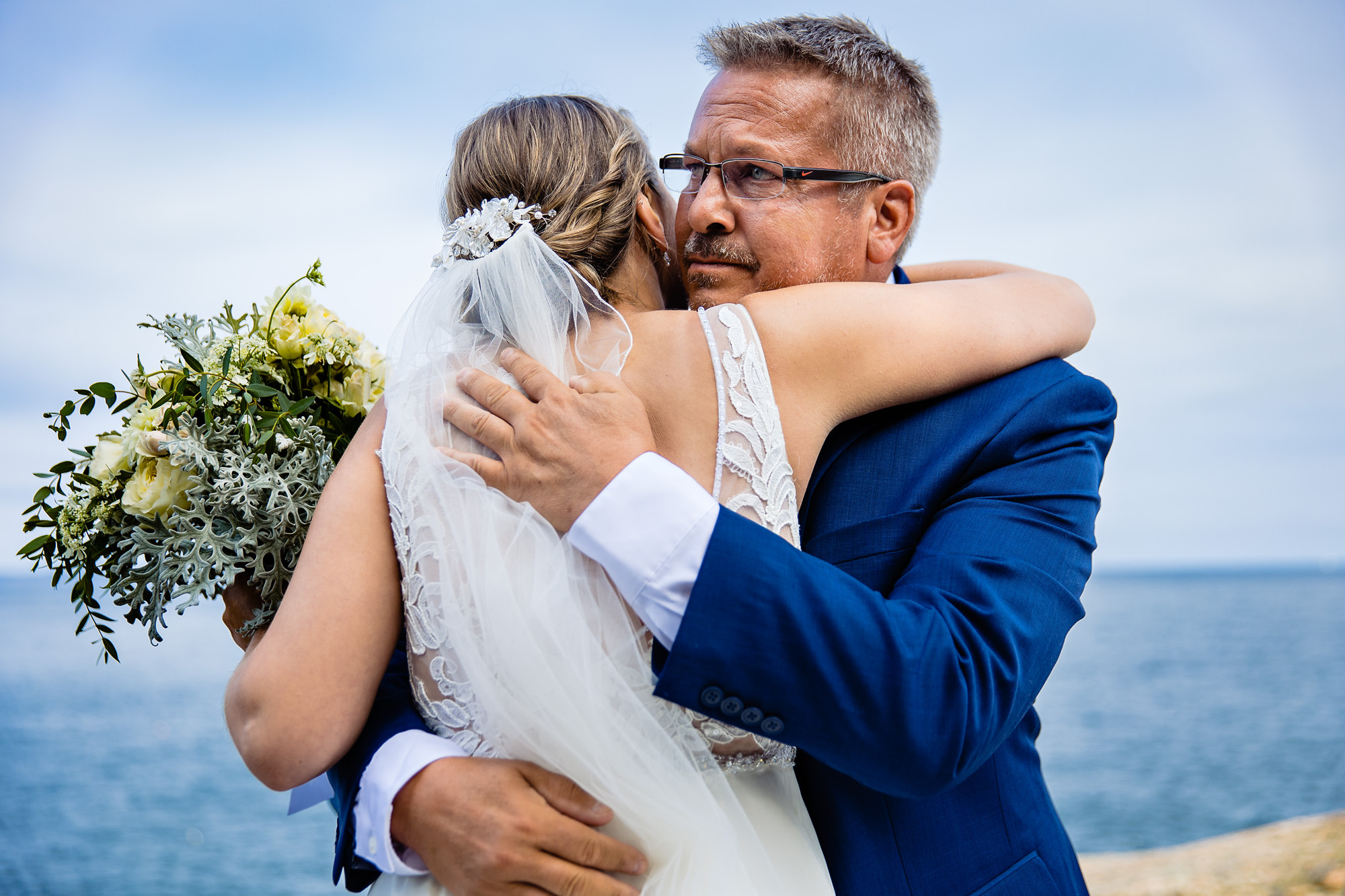 The bride hugs her father right before her Acadia elopement