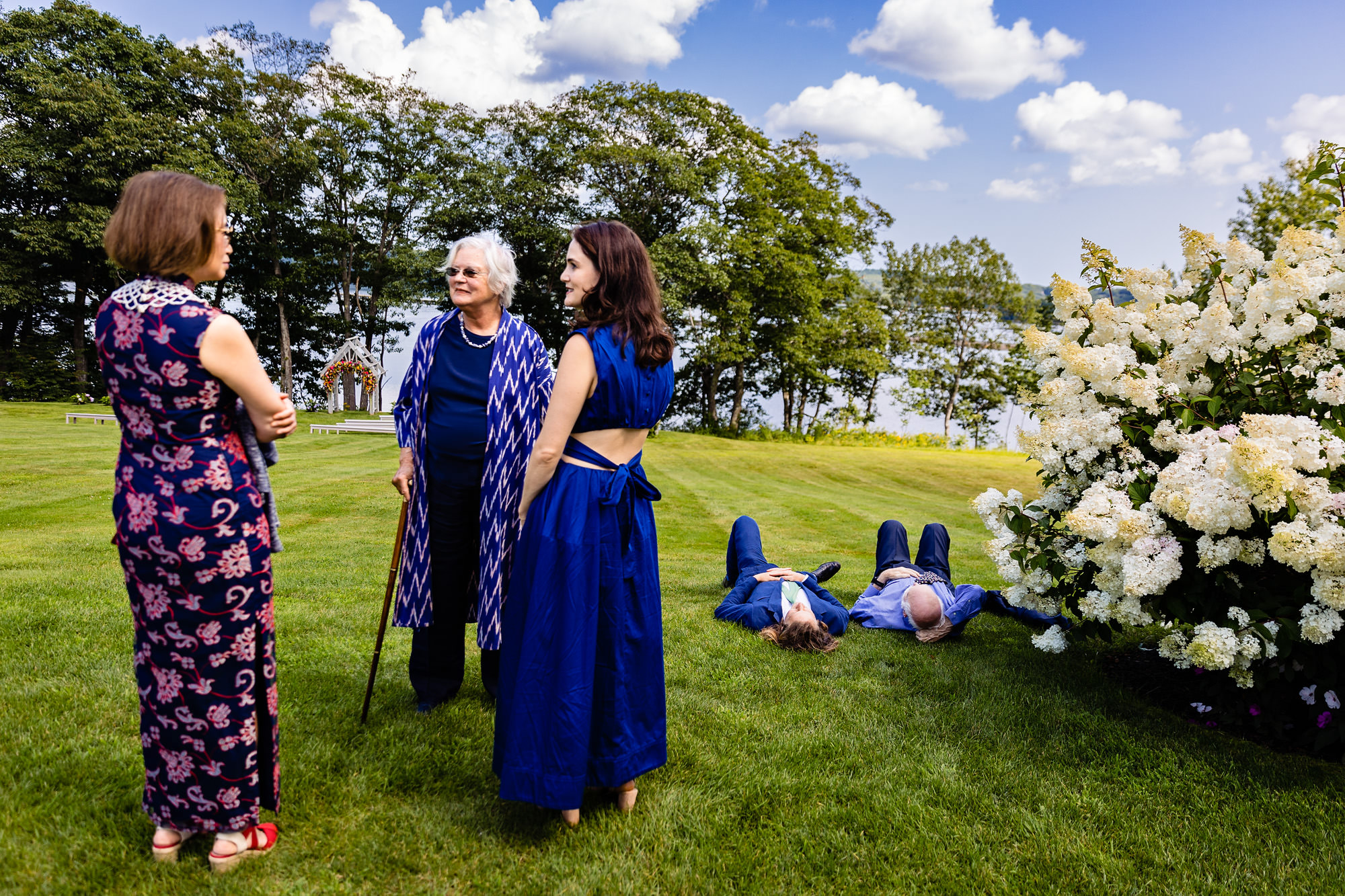 Two guests lie down before a wedding ceremony in Maine