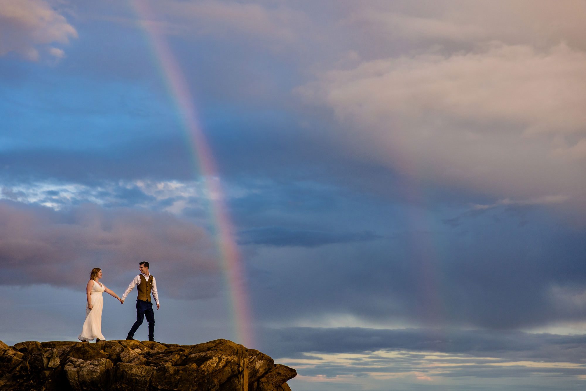 An Acadia National Park wedding portrait that features a rainbow.
