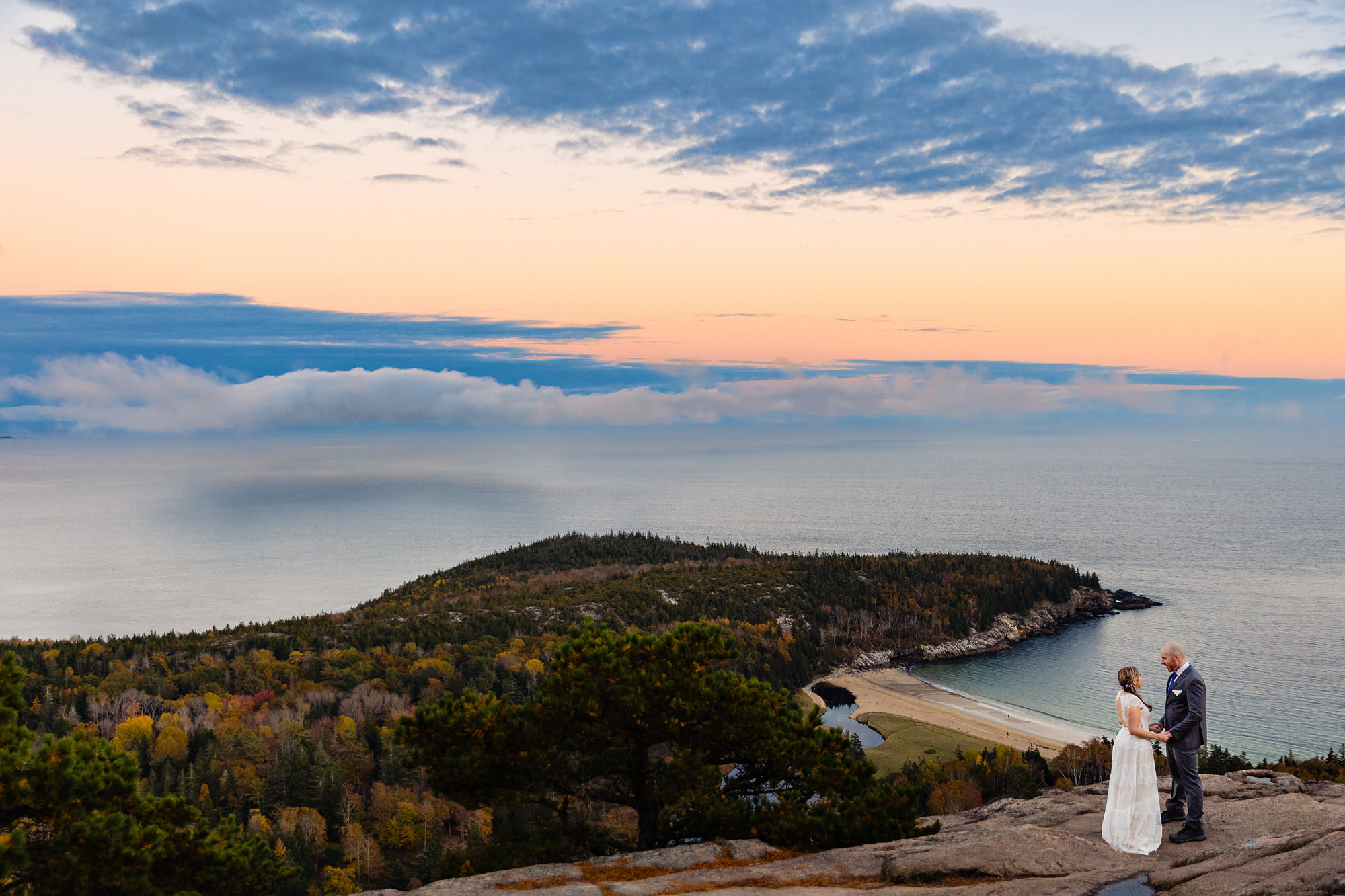 A stunning wedding portrait on top of a mountain in Acadia National Park