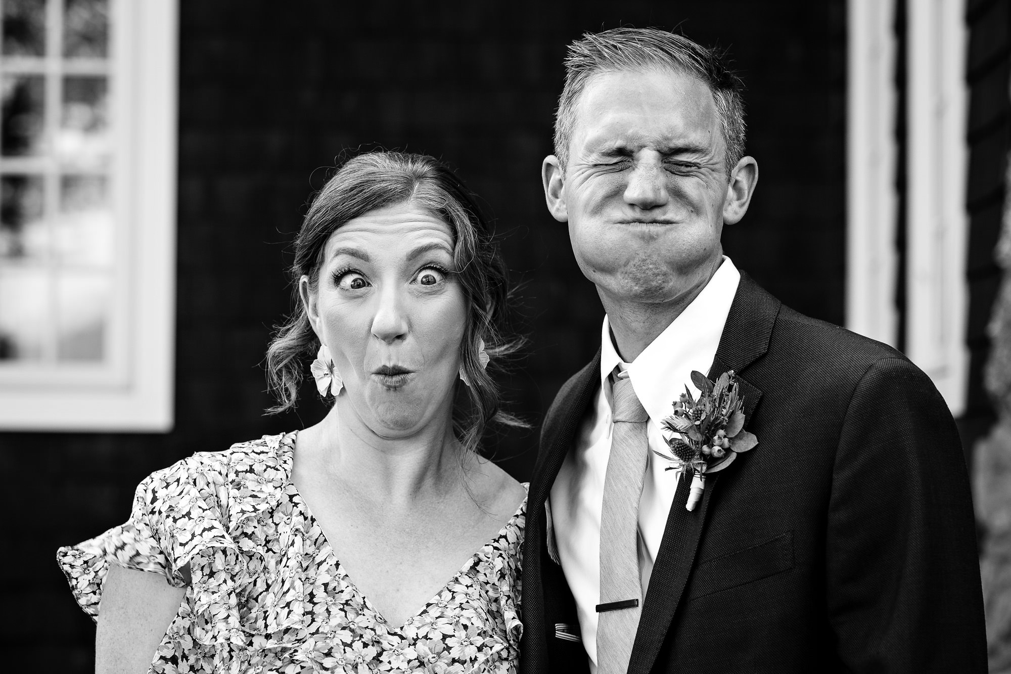 The groom and his sister make funny faces in front of the camera.