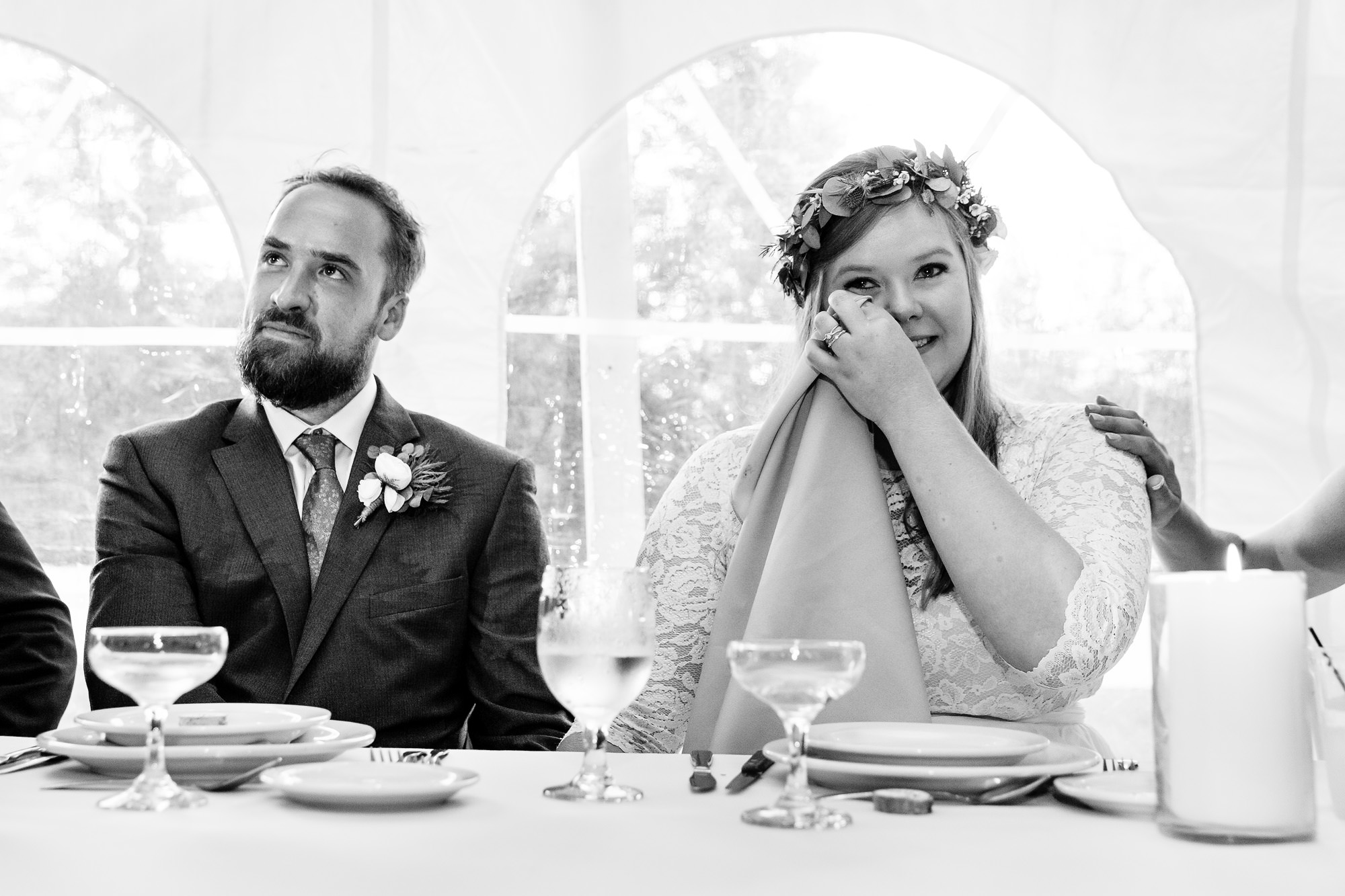A wedding couple gets emotional as they listen to toasts at their western Maine wedding.