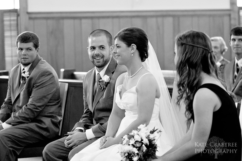 The bride and groom have a small moment during their wedding ceremony in Freeport Maine