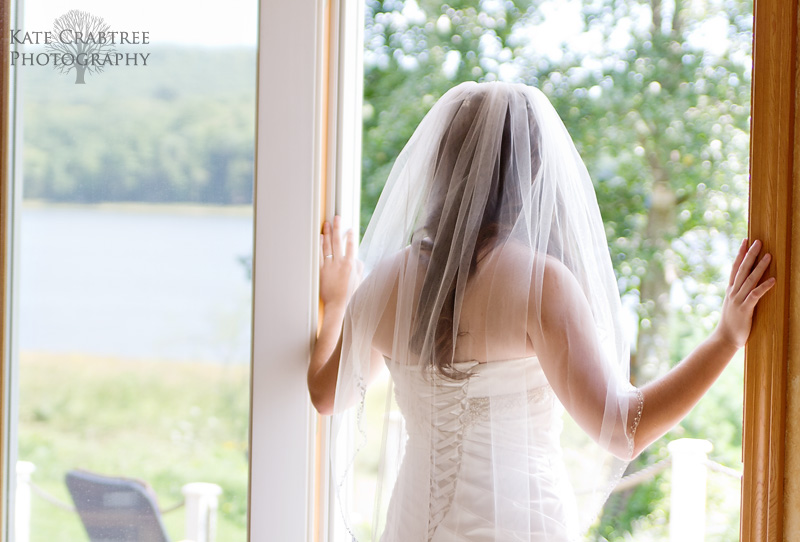 The bride looked at the scenic ocean view at her Winterport Maine home.