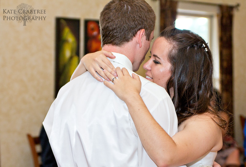 The bride shares a tender moment with her groom during their first dance at Winterport Winery in Maine.