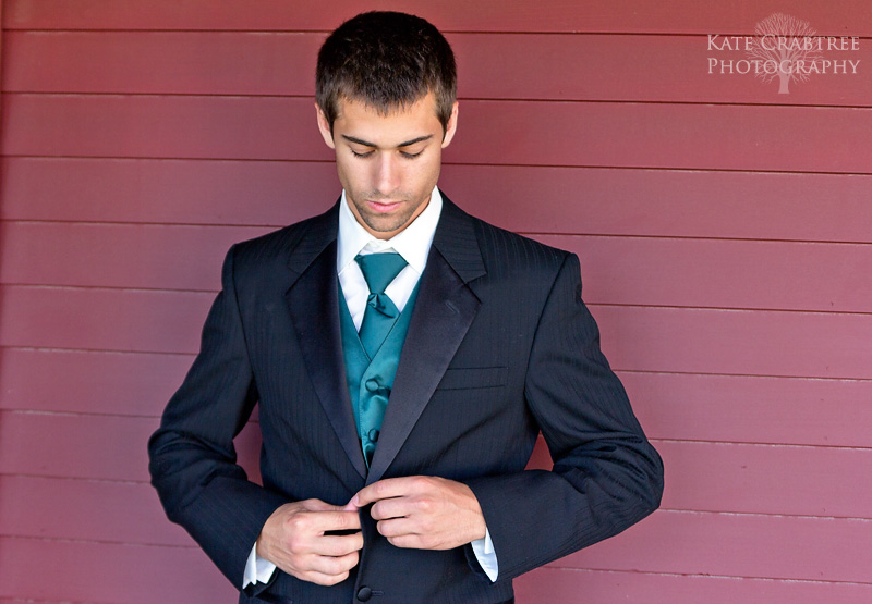 A groomsman poses at the Winterpory Winery at his friend's wedding.