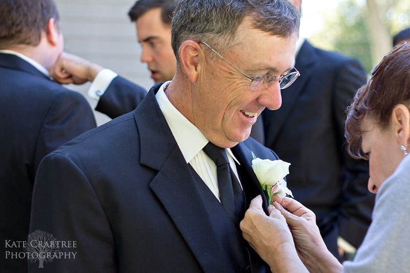 The father of the bride has his corsage pinned on before the Bangor Maine wedding commences.