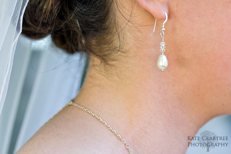 A detail shot of the bride's pearl earrings.