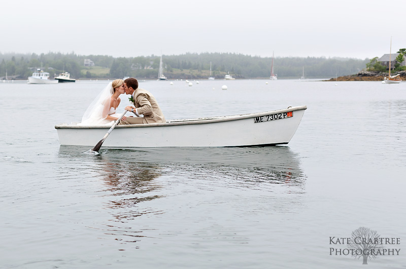 Formal portraits of the bride and groom in a rowboat at their coastal wedding in Maine