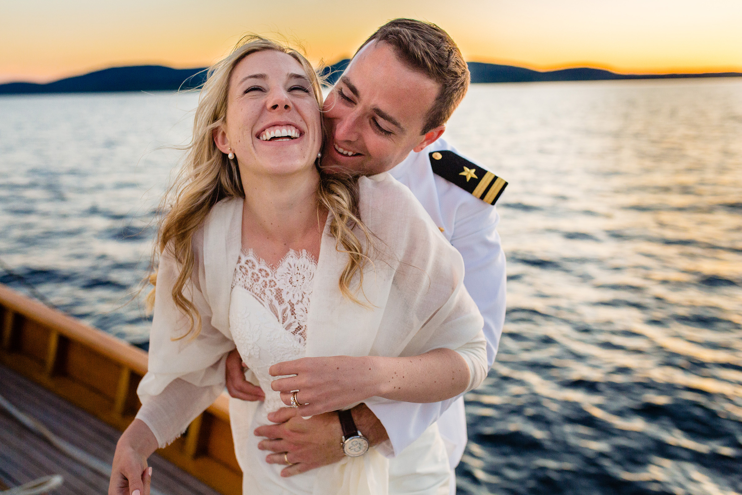 A couple hugs during a Camden Maine sailboat wedding