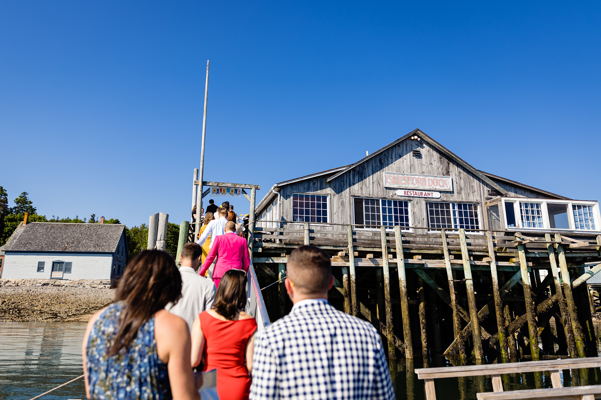 Wedding guests walk up to the Islesford Dock Restauant on Little Cranberry Island for Lance and Ames wedding
