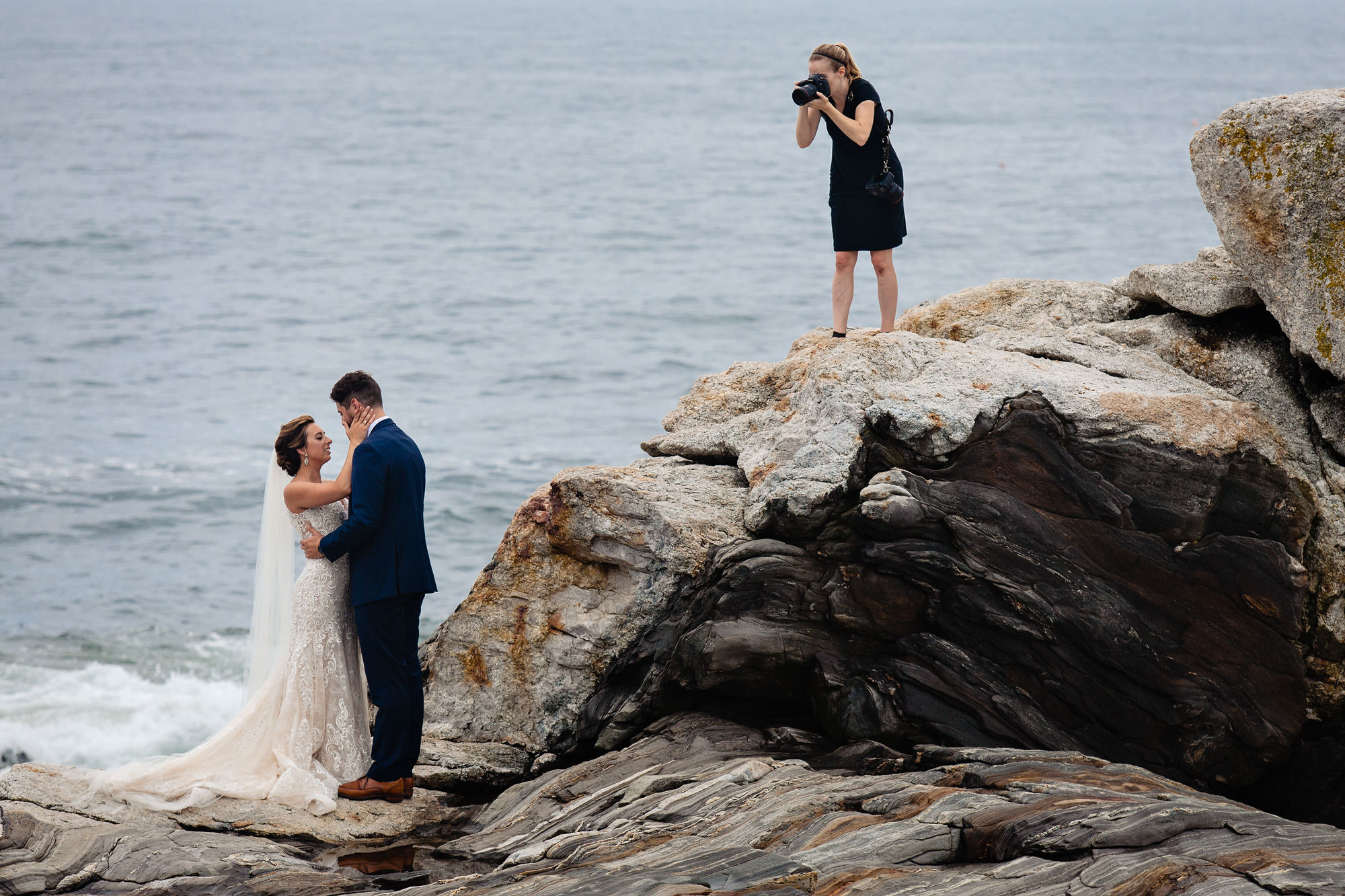 Kate Crabtree photographs a couple at a wedding at Pemaquid Point, Maine
