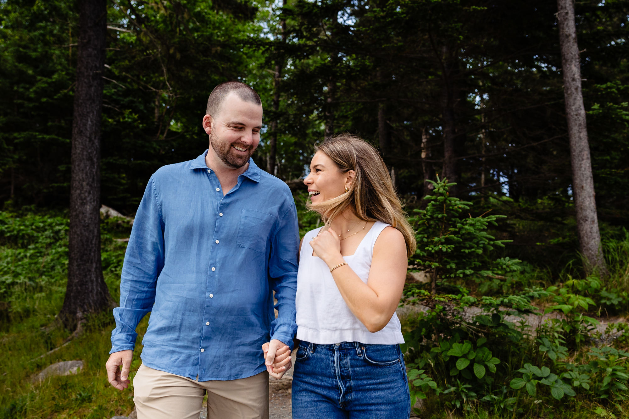 Happy engagement portrait taken in the woods of Acadia National Park