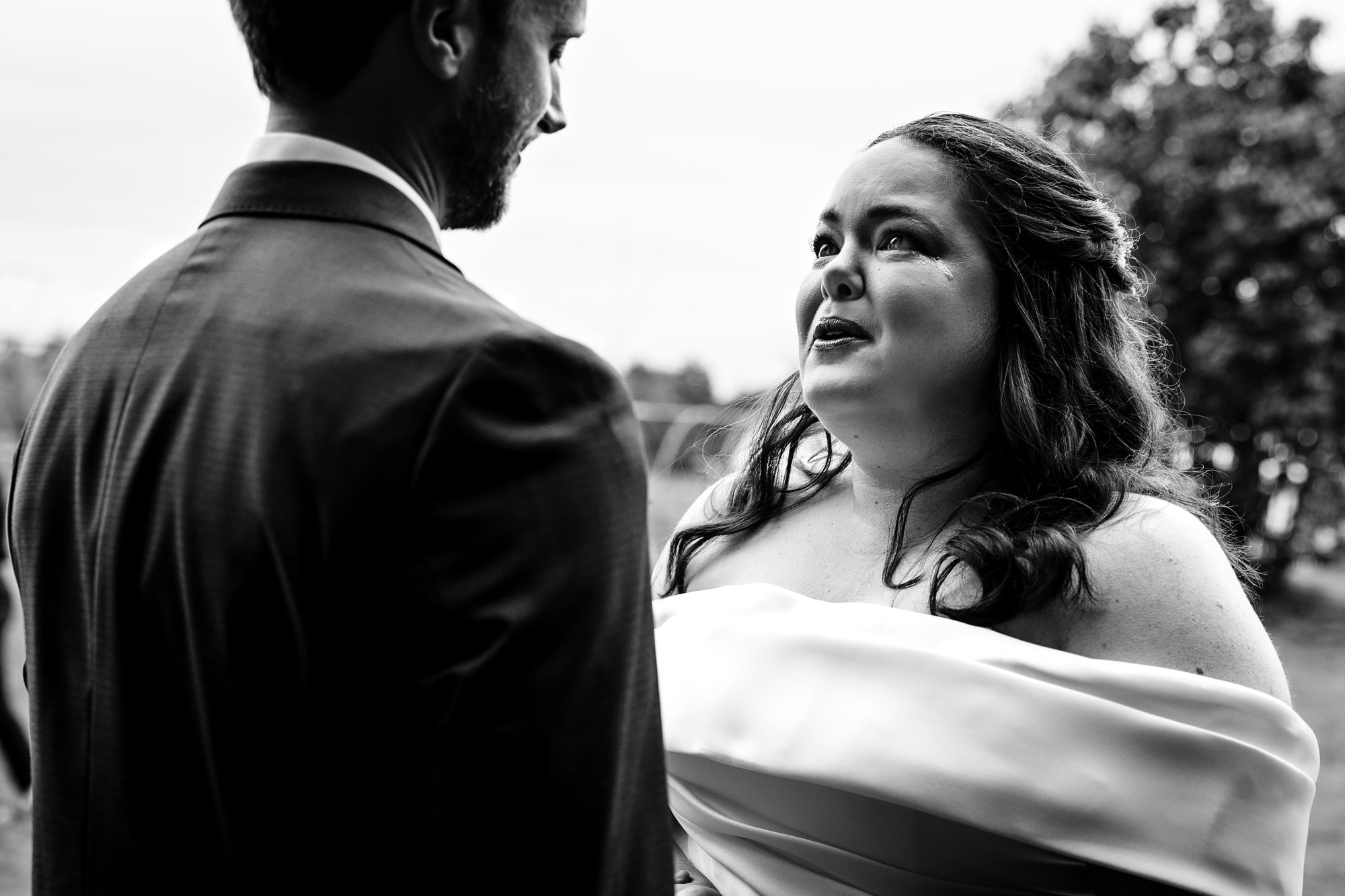 A bride cries during her first look at Broadturn Farm