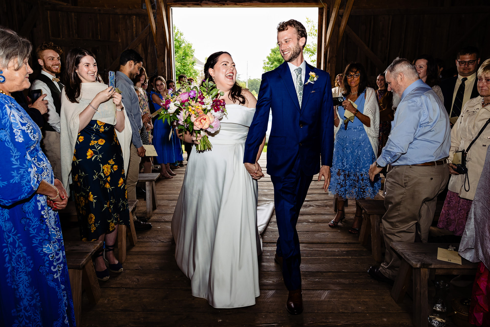 A wedding couple walks into their wedding ceremony together at their Broadturn Farm wedding