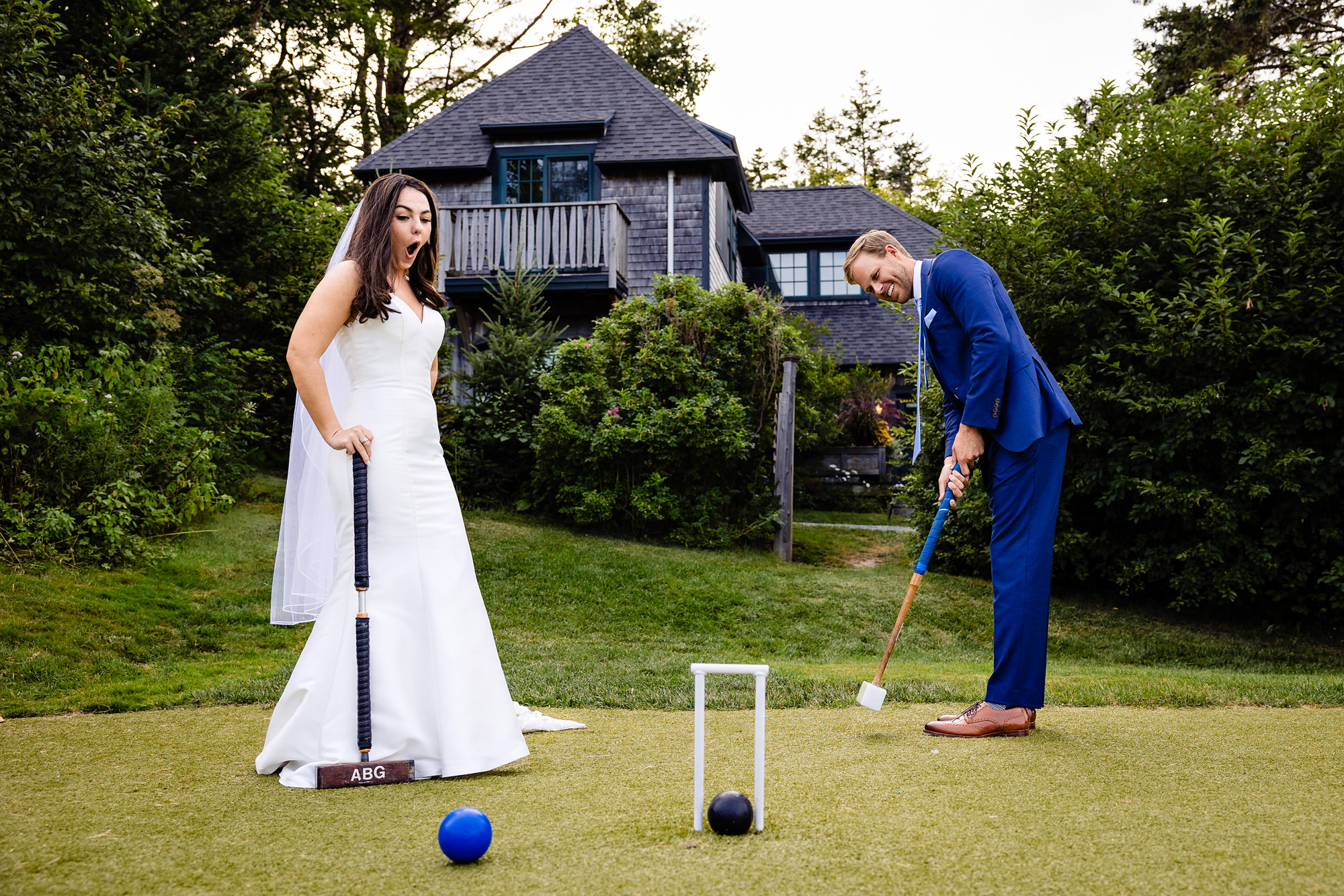 A bride and groom play croquet at Claremont Hotel at an Acadia Park elopement.