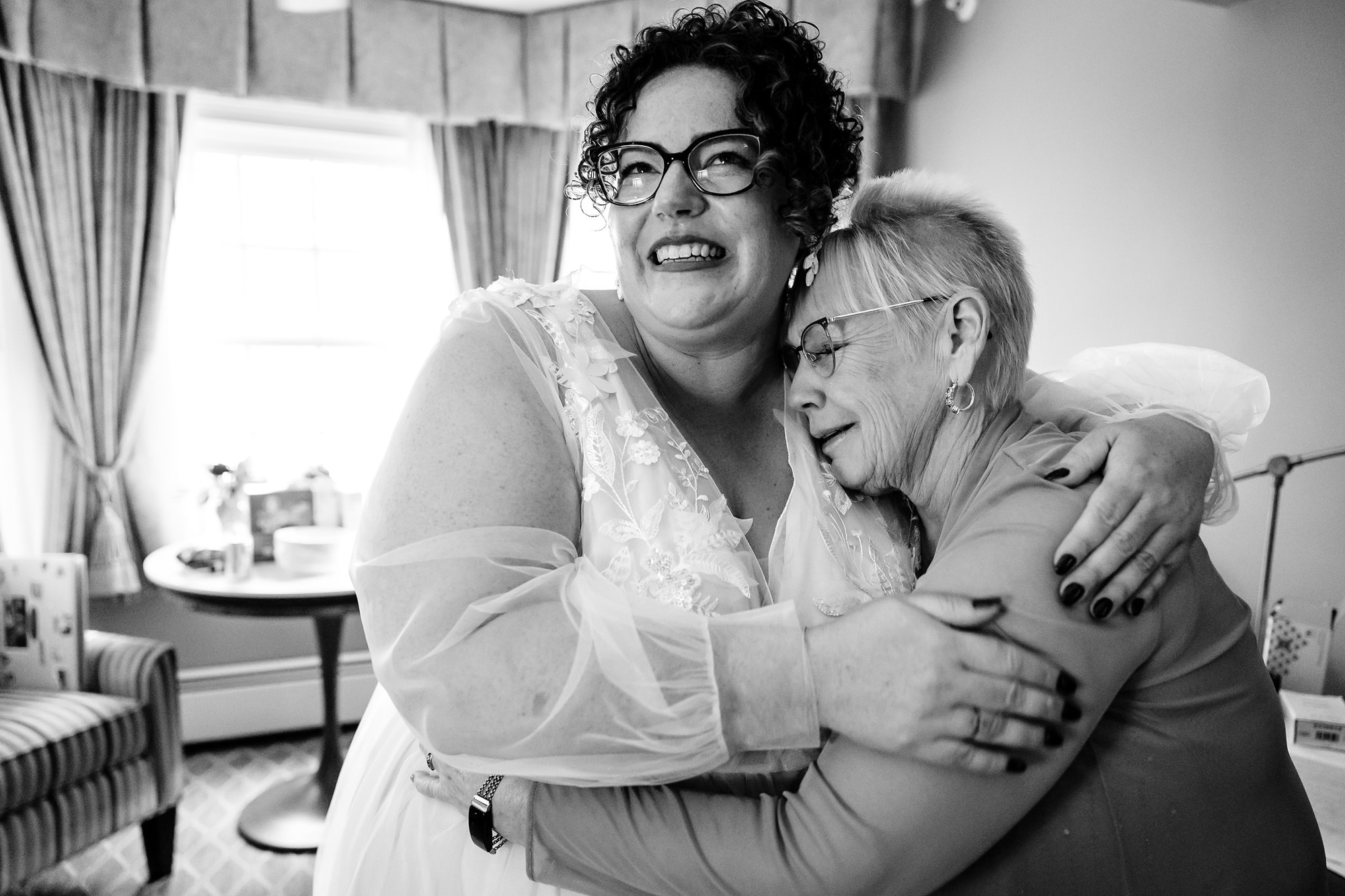 A bride hugs her mother in law at her Acadia elopement