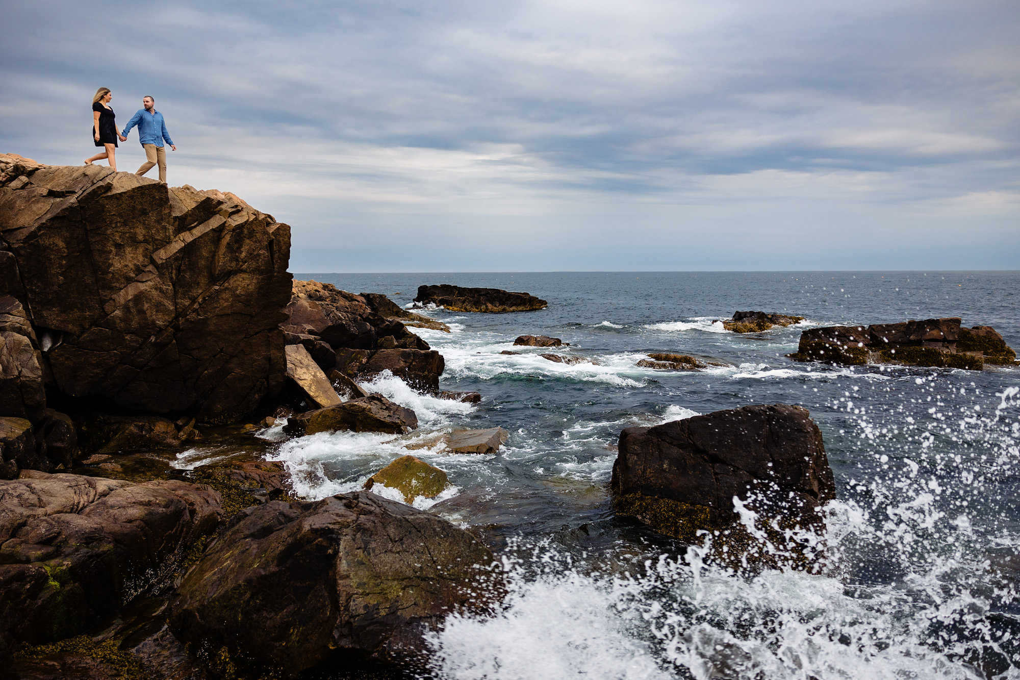 An engagement portrait taken at Otter Point in Acadia National Park