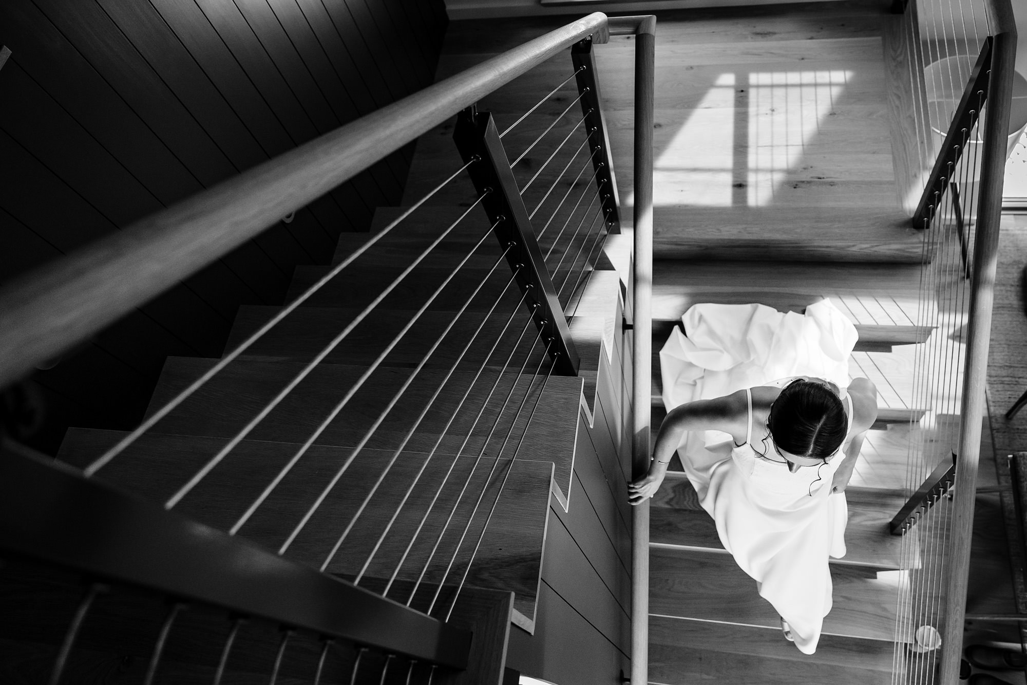 A bride walks down the stairs at her MDI wedding in Maine